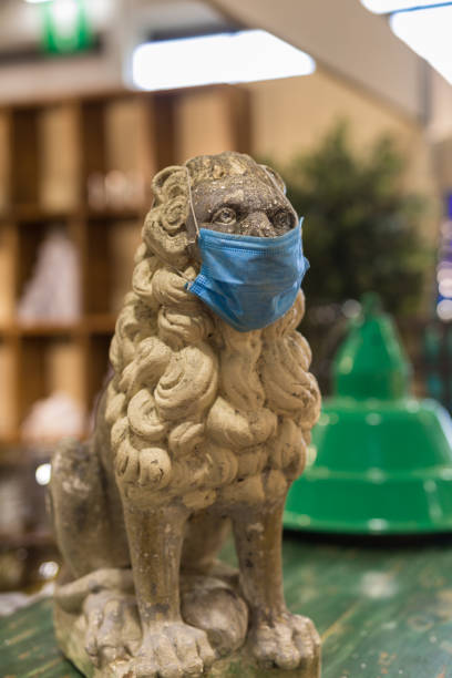 istock Marble Statue of a Lion Wearing a Surgical Mask 1283474849