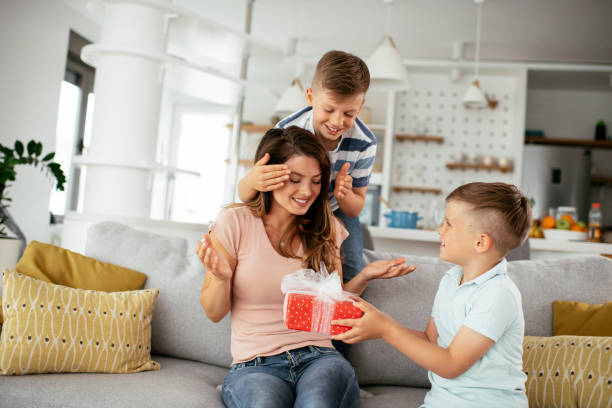 istock Two young sons are giving their mother a gift 1283474973