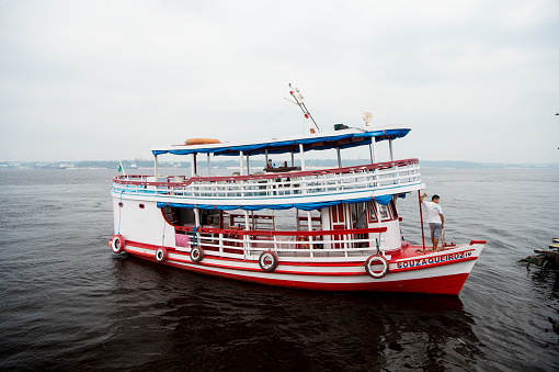 Manaus, Brazil - December 04, 2015: holiday cruiser ship on seascape. Pleasure boat float along sea coast. Summer vacation and travel. Wanderlust discovery and adventure. Water transport concept.