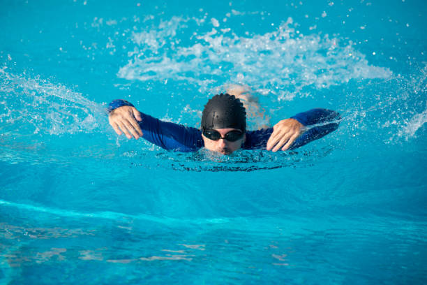 istock Man swimming in the pool on a sunny summer day 1283475351