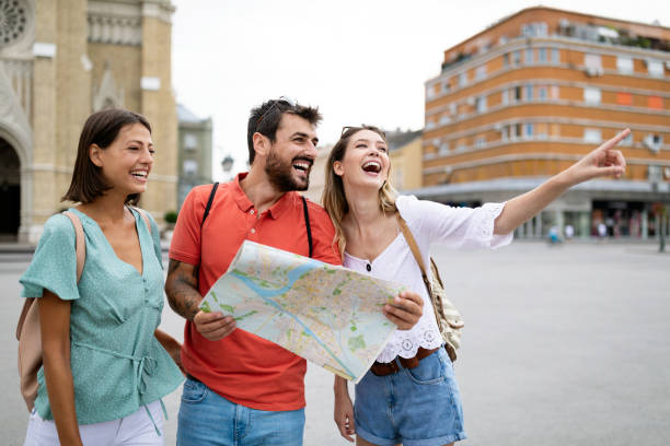 istock Happy traveling tourists sightseeing with map in hand 1283476496