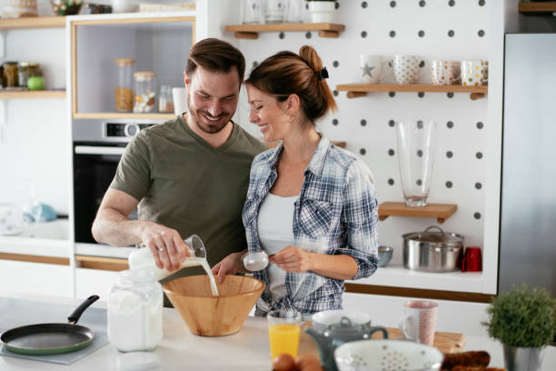 istock Husband and wife making pancakes at home. 1283476542