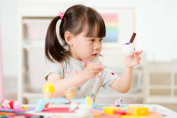 istock young girl decorating handmade craft for home schooling 1283477341