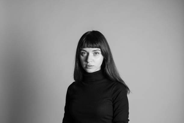 istock Studio portrait of a young woman against plain grey background 1283477395