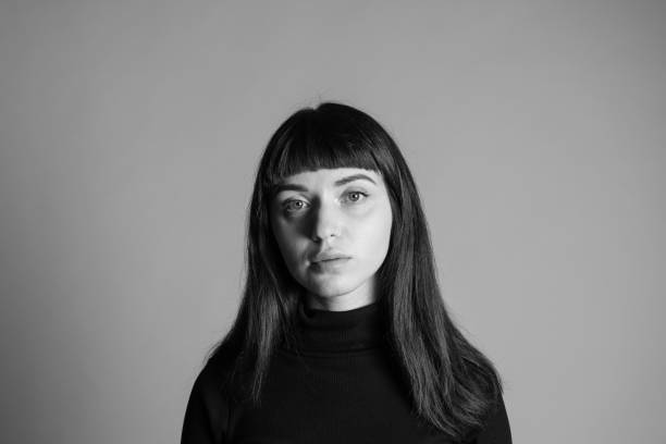 istock Close up studio portrait of a young woman against plain grey background 1283477406
