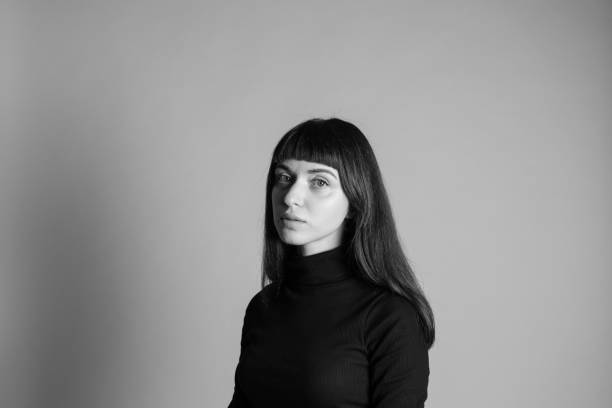 istock Studio portrait of a young woman against plain grey background 1283477407
