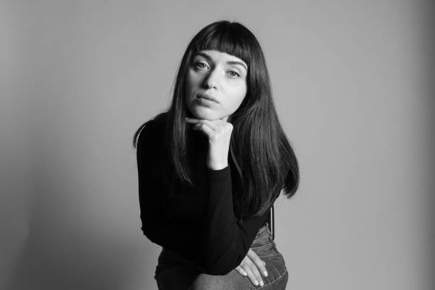 istock Studio portrait of a young woman against plain grey background 1283477409
