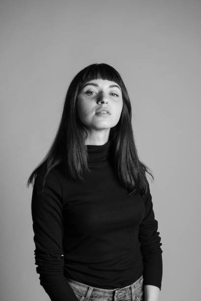 istock Studio portrait of a young woman against plain grey background 1283477411