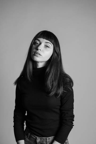 istock Studio portrait of a young woman against plain grey background 1283477414
