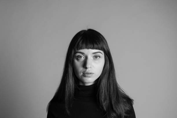 istock Studio portrait of a young woman against plain grey background 1283477415