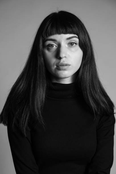 istock Studio portrait of a young woman against plain grey background 1283477419