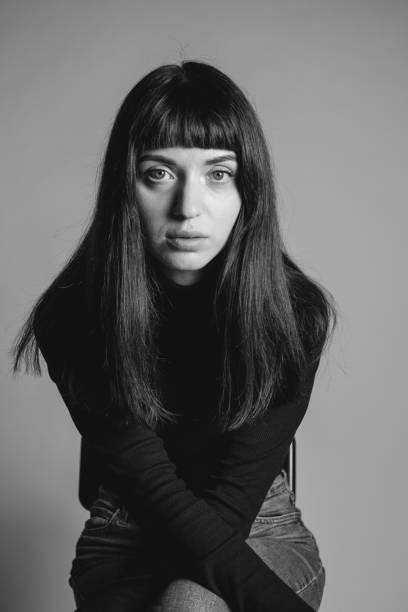 istock Studio portrait of a young woman against plain grey background 1283477437