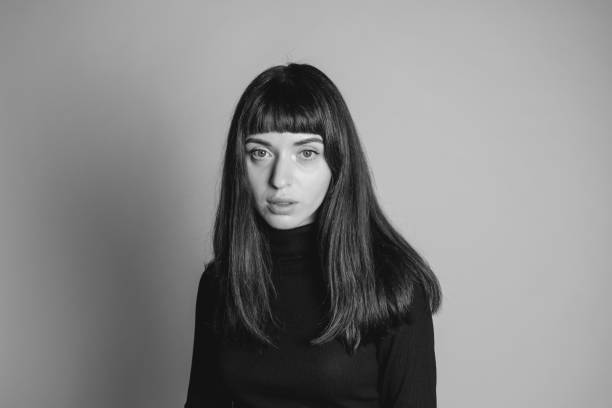 istock Studio portrait of a young woman against plain grey background 1283477439