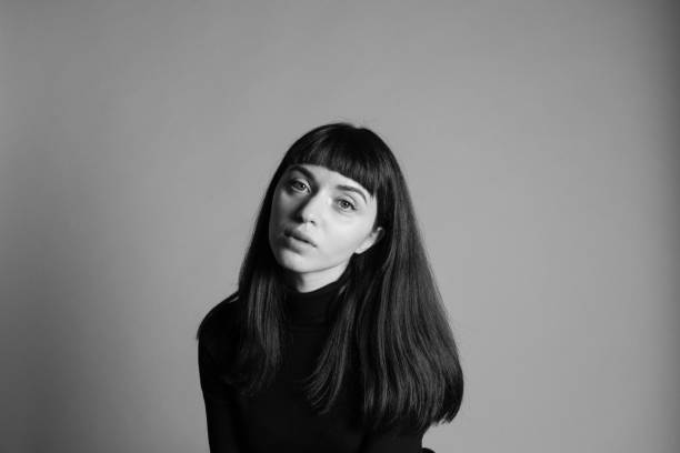 istock Studio portrait of a young woman against plain grey background 1283477443