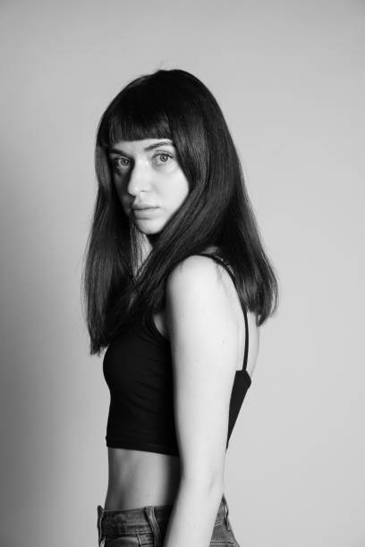 istock Studio portrait of a young woman against plain grey background 1283477446