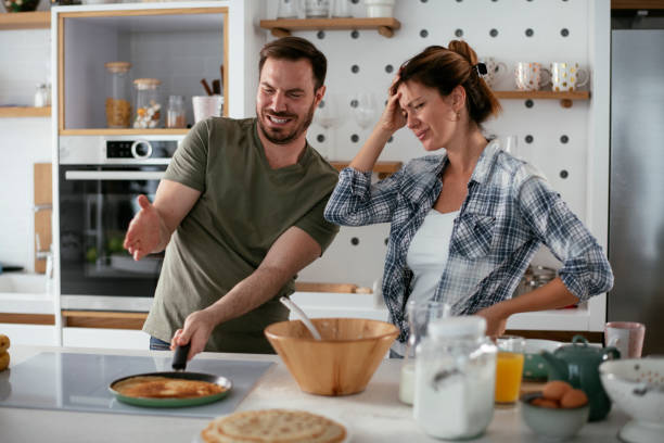 istock Husband and wife making pancakes at home. 1283477471