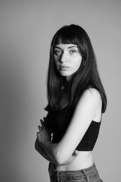 istock Studio portrait of a young woman against plain grey background 1283477480