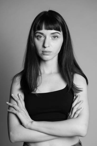 istock Studio portrait of a young woman against plain grey background 1283477482