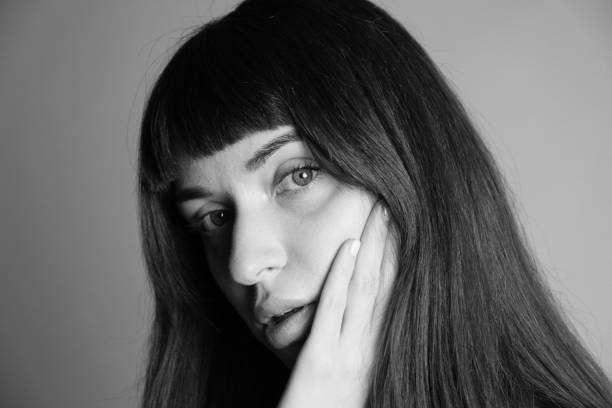 istock Studio portrait of a young woman against plain grey background 1283477486