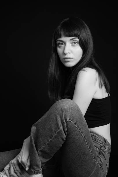 istock Studio portrait of a young woman against plain black background 1283477505