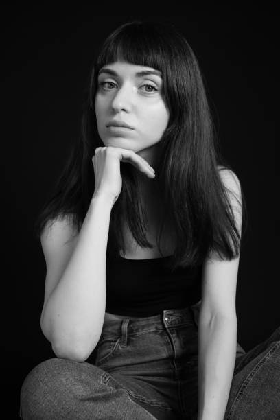 istock Studio portrait of a young woman against plain black background 1283477510