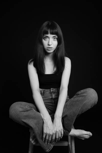istock Studio portrait of a young woman against plain black background 1283477511