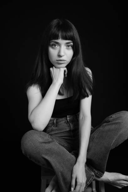 istock Studio portrait of a young woman against plain black background 1283477512