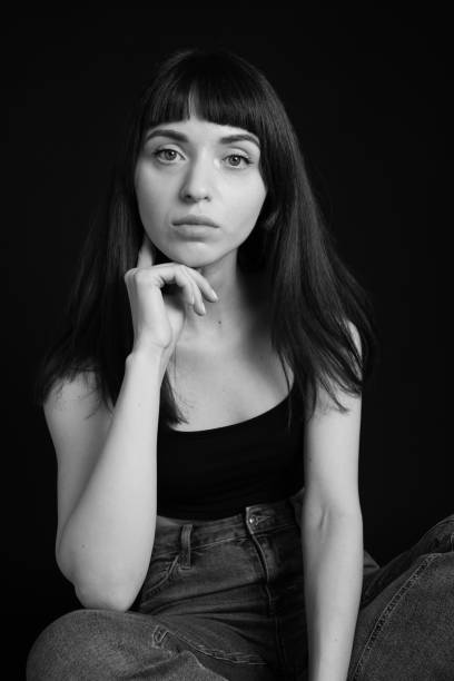 istock Studio portrait of a young woman against plain black background 1283477513