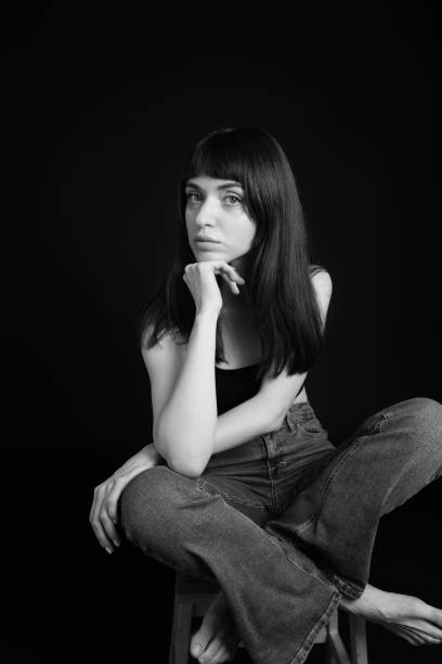 istock Studio portrait of a young woman against plain black background 1283477514