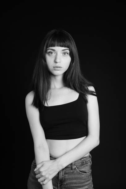 istock Studio portrait of a young woman against plain black background 1283477515