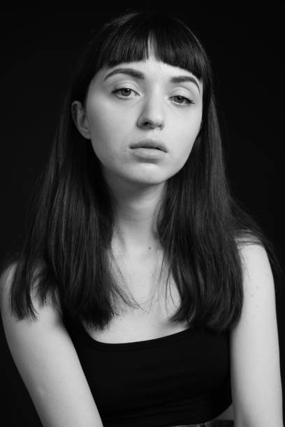 istock Studio portrait of a young woman against plain black background 1283477516