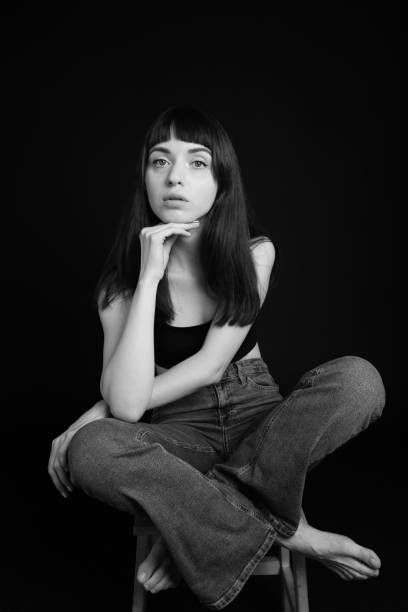 istock Studio portrait of a young woman against plain black background 1283477517