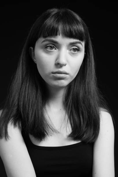 istock Studio portrait of a young woman against plain black background 1283477518