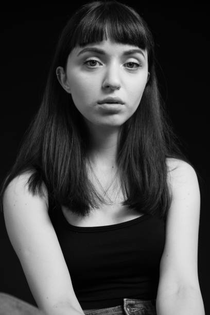 istock Studio portrait of a young woman against plain black background 1283477526