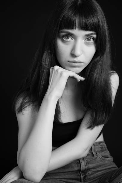 istock Studio portrait of a young woman against plain black background 1283477527