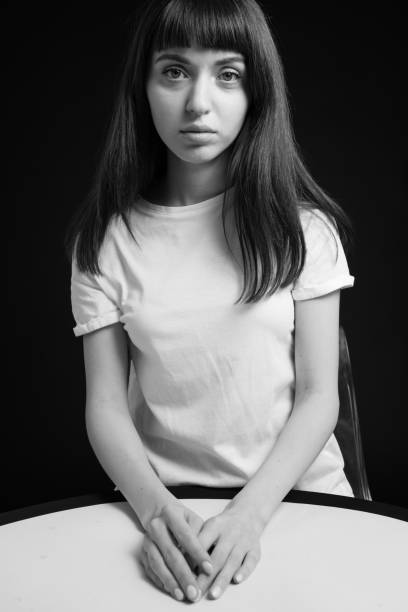 istock Studio portrait of a young woman against plain black background 1283480529
