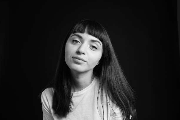 istock Studio portrait of a young woman against plain black background 1283480530