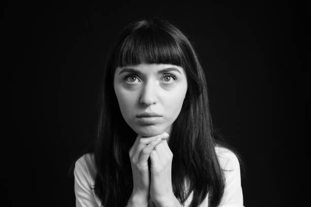 istock Studio portrait of a young woman against plain black background 1283480531