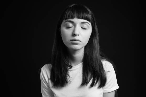 istock Studio portrait of a young woman against plain black background 1283480533