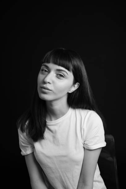 istock Studio portrait of a young woman against plain black background 1283480545
