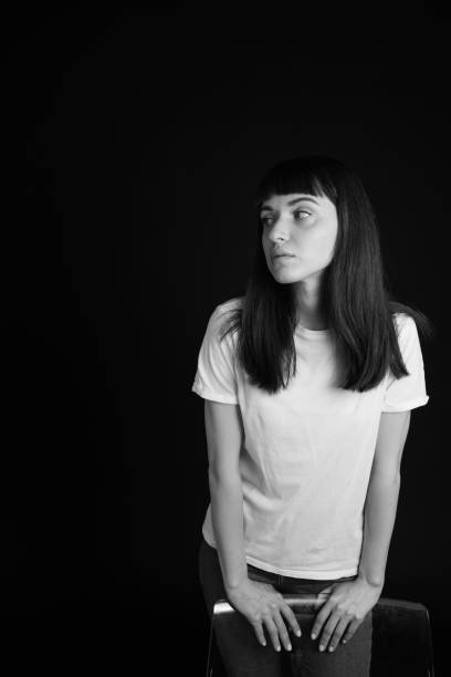 istock Studio portrait of a young woman against plain black background 1283480561