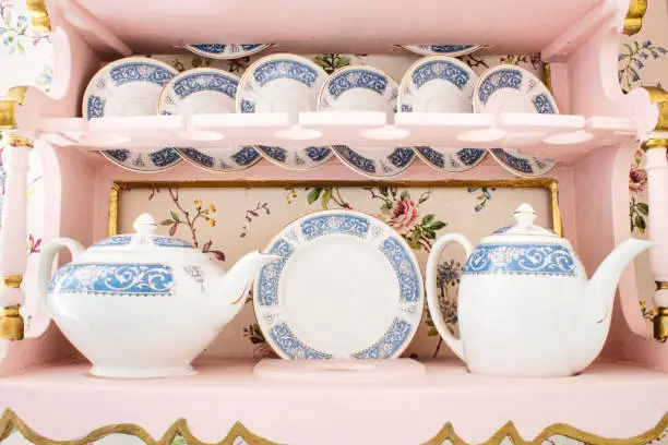 Delicate white porcelain china tea set with a selection of saucers, cups and teapots