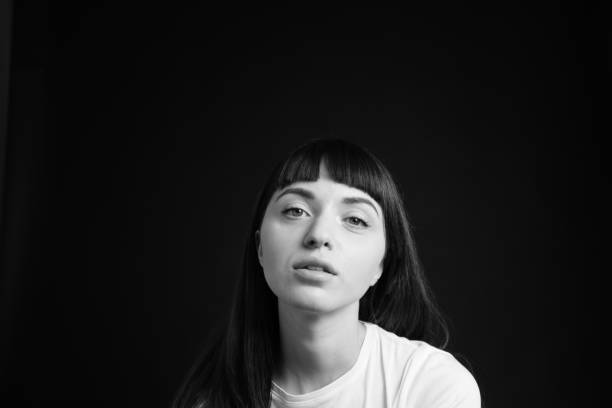istock Studio portrait of a young woman against plain black background 1283480575