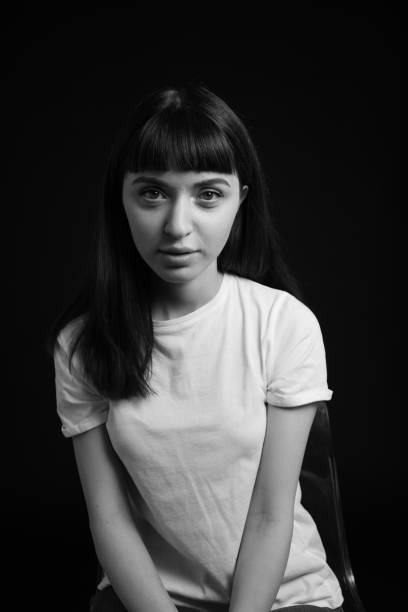 istock Studio portrait of a young woman against plain black background 1283480590