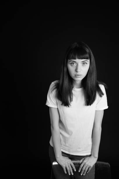 istock Studio portrait of a young woman against plain black background 1283480593