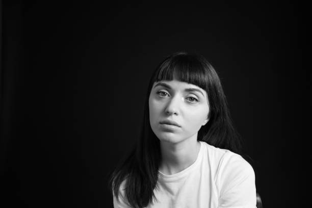 istock Studio portrait of a young woman against plain black background 1283480613