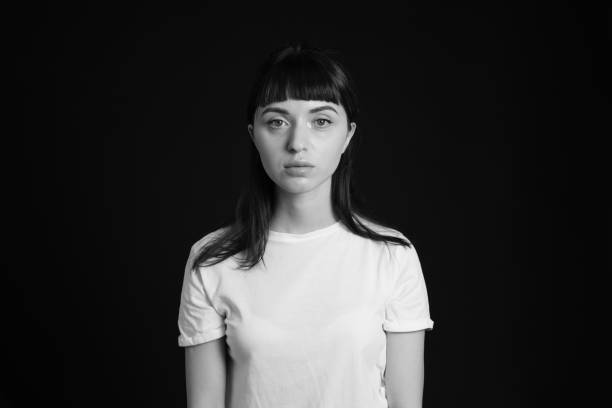 istock Studio portrait of a young woman against plain black background 1283480630