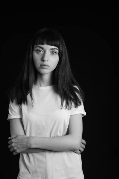 istock Studio portrait of a young woman against plain black background 1283480632