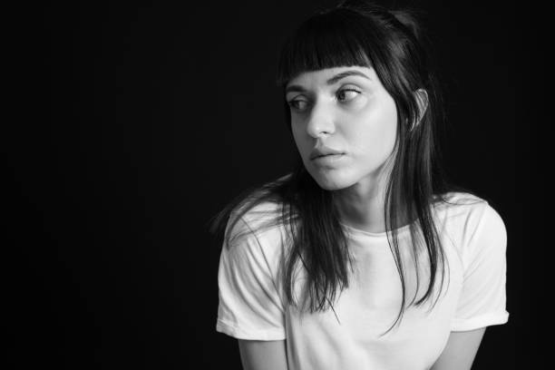 istock Studio portrait of a young woman against plain black background 1283480637