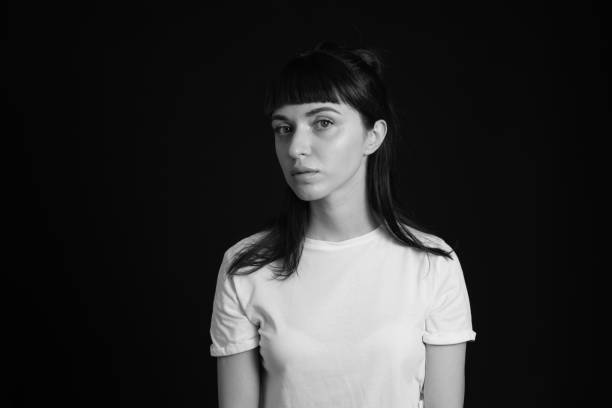 istock Studio portrait of a young woman against plain black background 1283480642